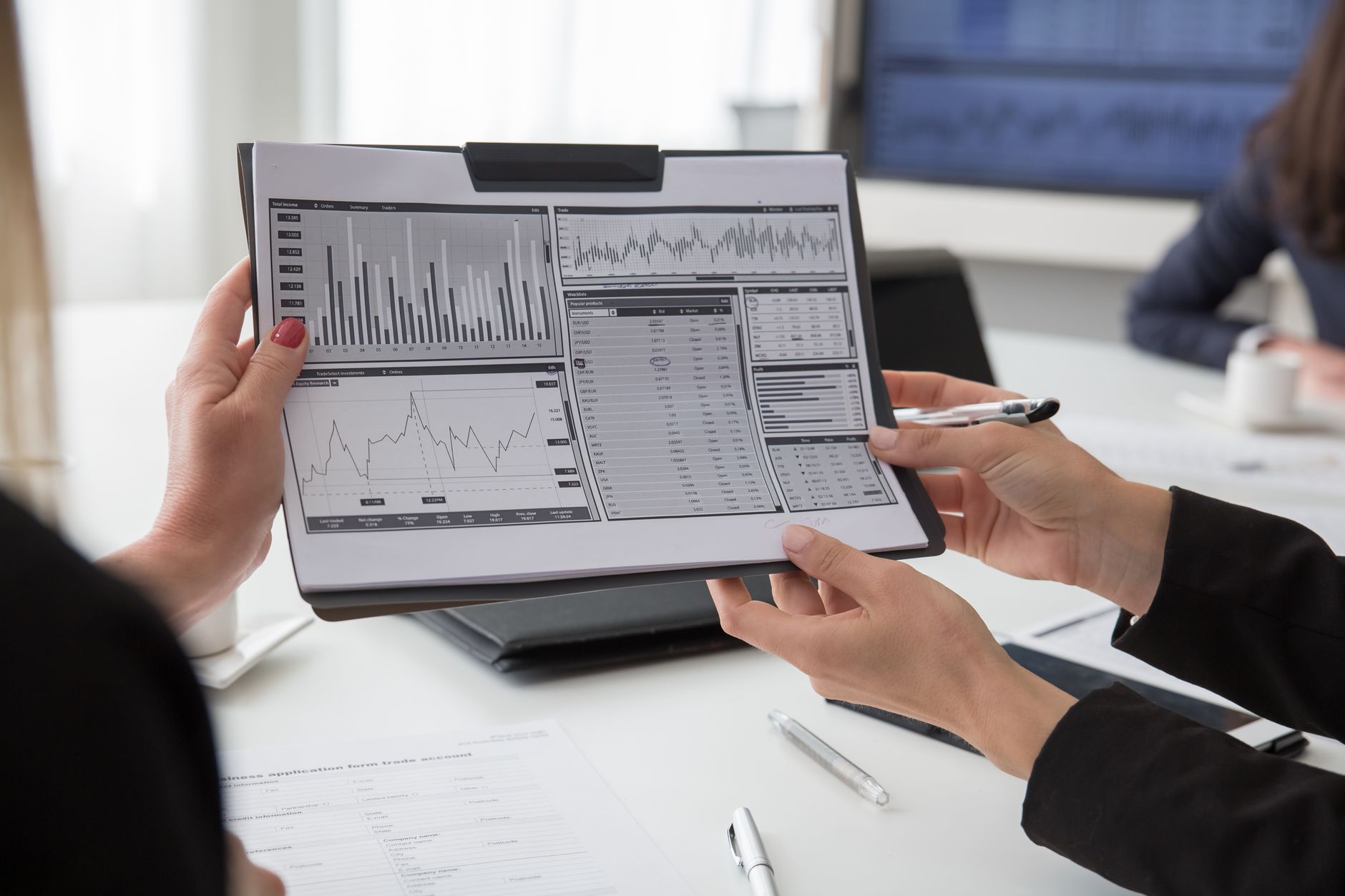 People reviewing graphs on a tablet